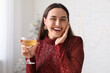 © Pixel-Shot - Beautiful young woman with glass of champagne in living room. Christmas celebration