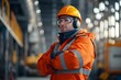 © Downloads - Confident Construction Worker in Protective Workwear Standing at Industrial Facility