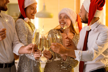 Sticker - Young people in Santa hats with champagne and Christmas sparklers at party