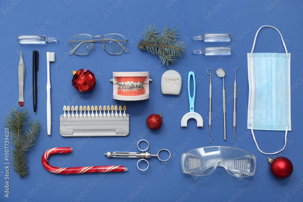 Dentist's supplies with Christmas decor on blue background