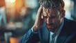 © Boomanoid - Businessman Struggling with Headache in Office, Stress and Fatigue in Professional Environment