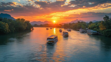 A beautiful sunrise over the River Kwai, with boats setting out for the day.