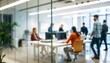 © Robiul - People are working in a blurred workplace behind a glass wall