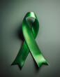 © anandart - World mental health day concept. Green awareness ribbon with copy space for text .