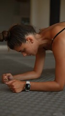 Wall Mural - Focused Fitness Woman Engaged in a Challenging Plank Exercise for Strength and Endurance