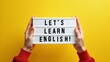 © KAMAKSI - Lets learn english lightbox message on a bright yellow background