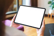 © Farknot Architect - Mockup image of a woman holding digital tablet with blank desktop screen at home