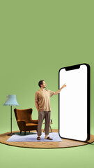 Man standing alone in simple room, pointing at giant 3D model of phone with blank screen. Use of mobile apps for efficiency and fast online services. Concept of modern technologies, gadgets