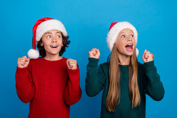 Wall Mural - Photo of two people kids raise fists up look empty space isolated blue color background