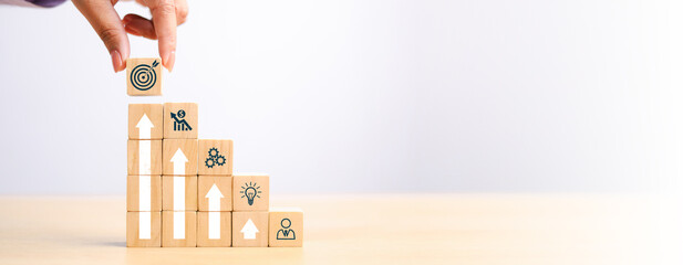 Wall Mural - woods block step on table with icon action plan, goal and target, success and business target concep