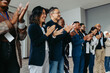 © Jacob Lund - Diverse group of business employees applauding during a celebration event