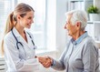 © Wanlop - Woman Doctor and Elderly Patient Engaging in a Friendly Handshake in a Medical Office Setting