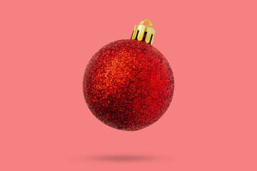Wall Mural - Red Christmas ball isolated on pink background