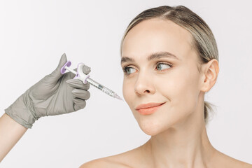 A woman confidently poses against a white background beside a syringe. This image captures the essence of cosmetic services, highlighting the importance of self-care and skin health.