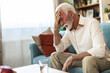 © Jelena Stanojkovic - Senior, man and pain from headache in home with stress, frustrated or confused from brain fog in retirement. Elderly, african person and migraine with tension, pressure and mental health with anxiety.