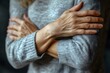 © mangolovemom - A woman is wearing a gray sweater and has her arms crossed