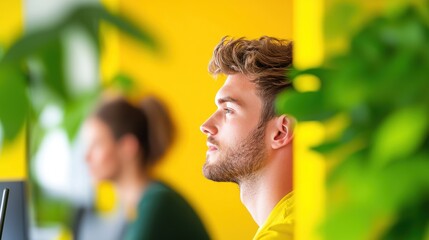 Wall Mural - A team of developers working on a project in a modern, open plan office space, with natural light and vibrant colors.