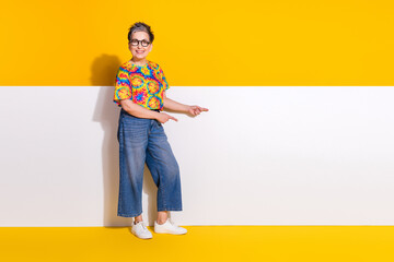 Wall Mural - Full size photo of nice aged lady direct fingers empty space wear t-shirt isolated on yellow color background