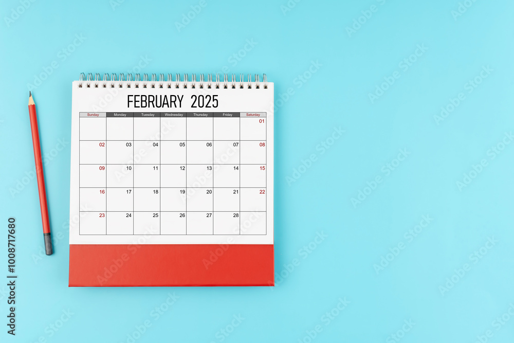 February desk calendar for 2025 year with pencil on blue background ...