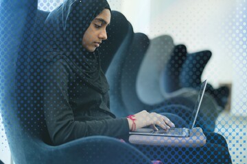 Islamic girl sitting and using laptop