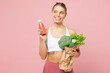 © ViDi Studio - Young happy woman wear white top casual clothes hold packet with vegetables, bottle orange juice smoothie isolated on plain pink background Proper nutrition healthy fast food unhealthy choice concept
