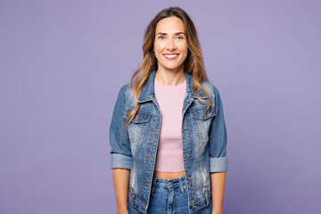 Young smiling happy cheerful fun cool satisfied woman she wear denim jacket violet top casual clothes look camera isolated on plain pastel light purple background studio portrait. Lifestyle concept.