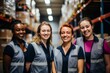 © Baba Images - Smiling portrait of a young and diverse group of female warehouse workers