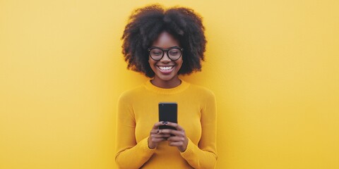 Sticker - A woman with curly hair and glasses is smiling while holding a cell phone. She is happy and engaged with her phone