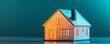 © auc - Miniature house model with warm lighting on a colorful background.