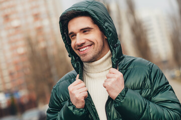 Sticker - Photo of cheerful dreamy man walking on city street in cold autumn weather warm clothes