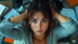 © julija - exhausted woman with disheveled hair seated in a cluttered office space her anxious expression and sweaty forehead reflect overwhelming stress and fatigue in a gloomy gray atmosphere