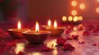 © Fotograf - Three lit candles sit on a table surrounded by rose petals
