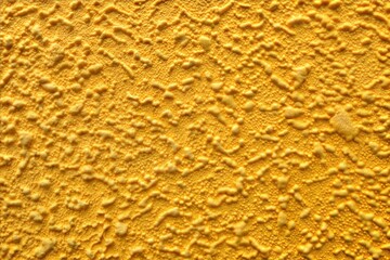 Wall Mural - close-up of yellow textured wall with abstract background