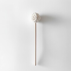 Poster - A minimalist image of a fluffy pom-pom on a stick against a plain background.