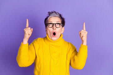 Wall Mural - Photo of impressed positive woman wear yellow sweater showing two fingers up empty space isolated violet color background