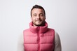 © Markus Schröder - Portrait of a blissful man in his 30s dressed in a thermal insulation vest on white background
