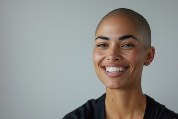 Wall Mural - Portrait of a woman with a shaved head smiling directly at the camera