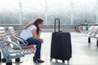 © Song_about_summer - flight delay or cancellation, sad angry woman passenger in airport, travel insurance