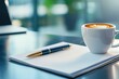 © Vangly - A warm cup of coffee beside a pen and notepad on a sleek desk.