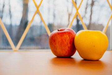 Japanese yellow and red apples on table close-up