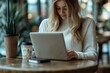 © dgpatel - Businesswoman working remotely with laptop and smartphone in a coffee shop, Generative AI