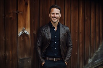 Sticker - Portrait of a joyful man in his 40s sporting a stylish leather blazer while standing against rustic wooden wall