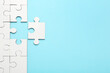 © New Africa - White puzzle pieces on light blue background, top view. Space for text