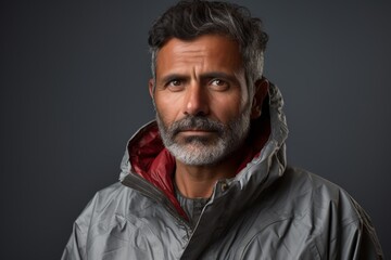 Canvas Print - Portrait of a tender indian man in his 50s wearing a windproof softshell over modern minimalist interior