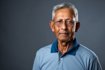 Wall Mural - Portrait of a merry indian man in his 70s wearing a breathable golf polo in front of modern minimalist interior