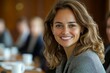 © Lotus Frames - Business woman smiling at the camera during a team meeting in a boardroom, Generative AI