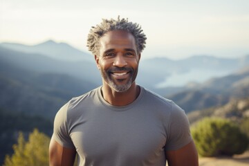 Canvas Print - Portrait of a cheerful afro-american man in his 40s donning a trendy cropped top isolated in backdrop of mountain peaks