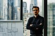 © DesignByGade - A confident man in a black shirt stands in front of a window with a city view.