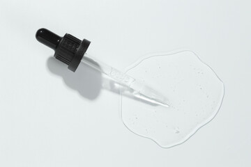 Poster - Pipette with cosmetic serum on light background, top view