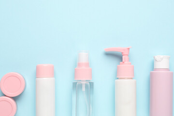 Poster - Different cosmetic products on light blue background, flat lay